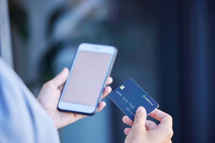 Credit card, woman hands and mobile phone for ecommerce payment, fintech money and online shopping. Closeup customer, cellphone banking and digital finance of mockup, internet or financial technology
