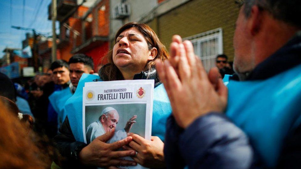 A person holds a picture of Pope Francis as faithful attend a mass to rebuff attacks on Pope Francis by presidential candidate Javier Milei, of La Libertad Avanza coalition, in the villa 21-24 neighbourhood, in Buenos Aires, Argentina, September 5, 2023.